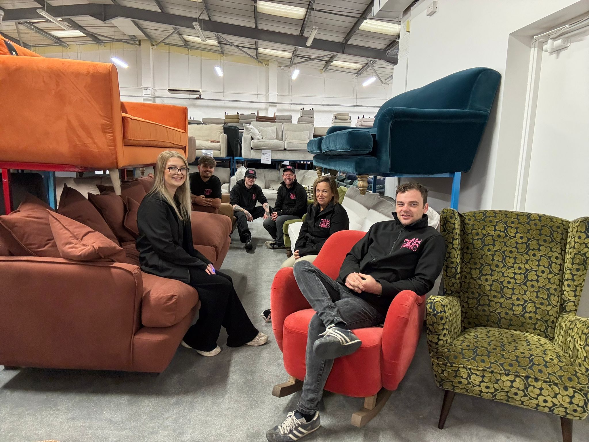 Team members of 2 Pink Flamingos furniture store inside the warehouse