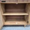 inside the cupboard space of the sideboard which includes and shelf